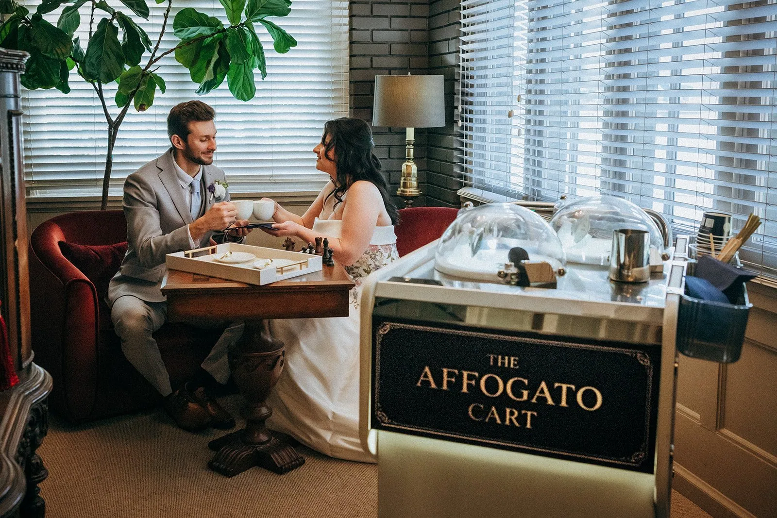 A couple sharing their first coffee from The Affogato Cart at their wedding