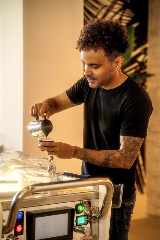 Sam pouring espresso-style coffee over gelato at the cart